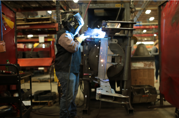 A photo of a Steffes welder welding a piece of metal equipment